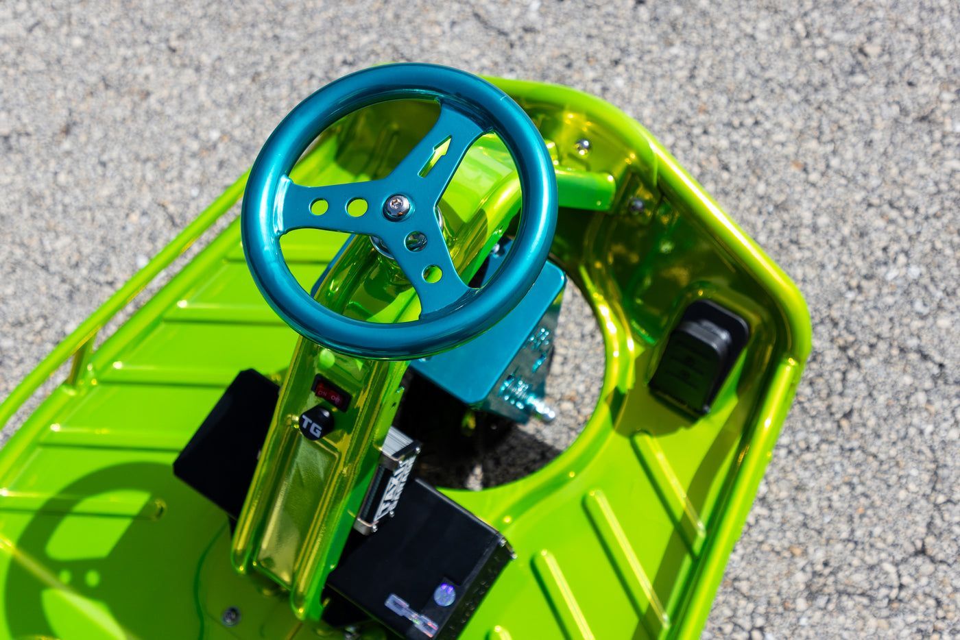 Lime cart with teal steering wheel and speed controller